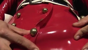 blonde lady-man In Red Latex costume Plays With Her biggest milk shakes And Jerks Off